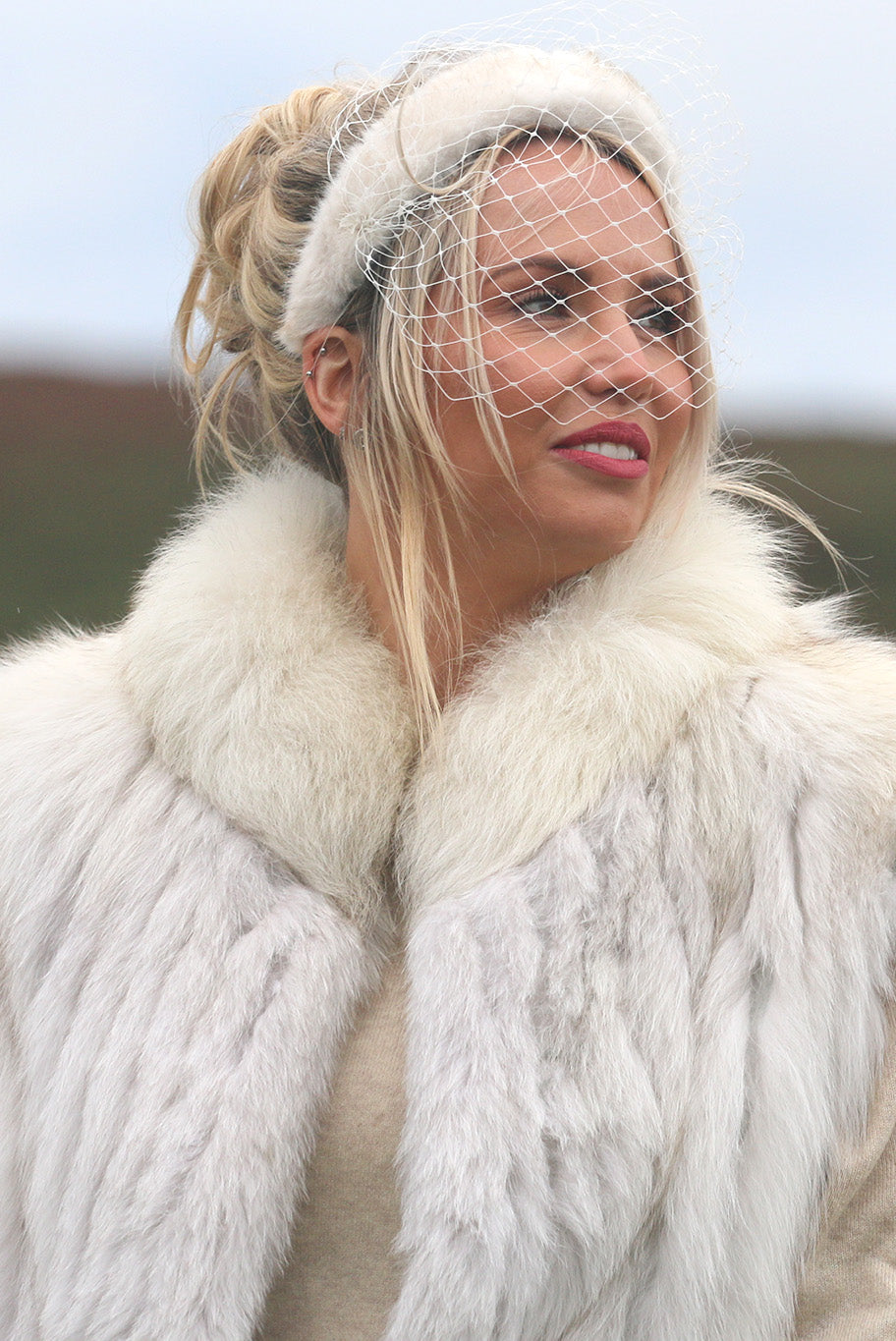 Faux fur headband with birdcage veil and diamante brooch